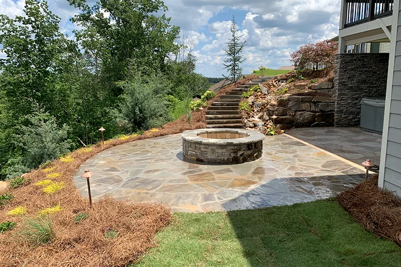 patio with fire pit and new straw